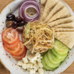 BABA GHANOUSH (Roasted Eggplant Dip) ~ GF on request / Vegan on request Charred eggplant, tahini, cumin oregano, paprika, black pepper, garlic, onion, extra virgin olive oil, tomatoes, parsley, lemon, olives, cayenne, grilled pita, feta cheese